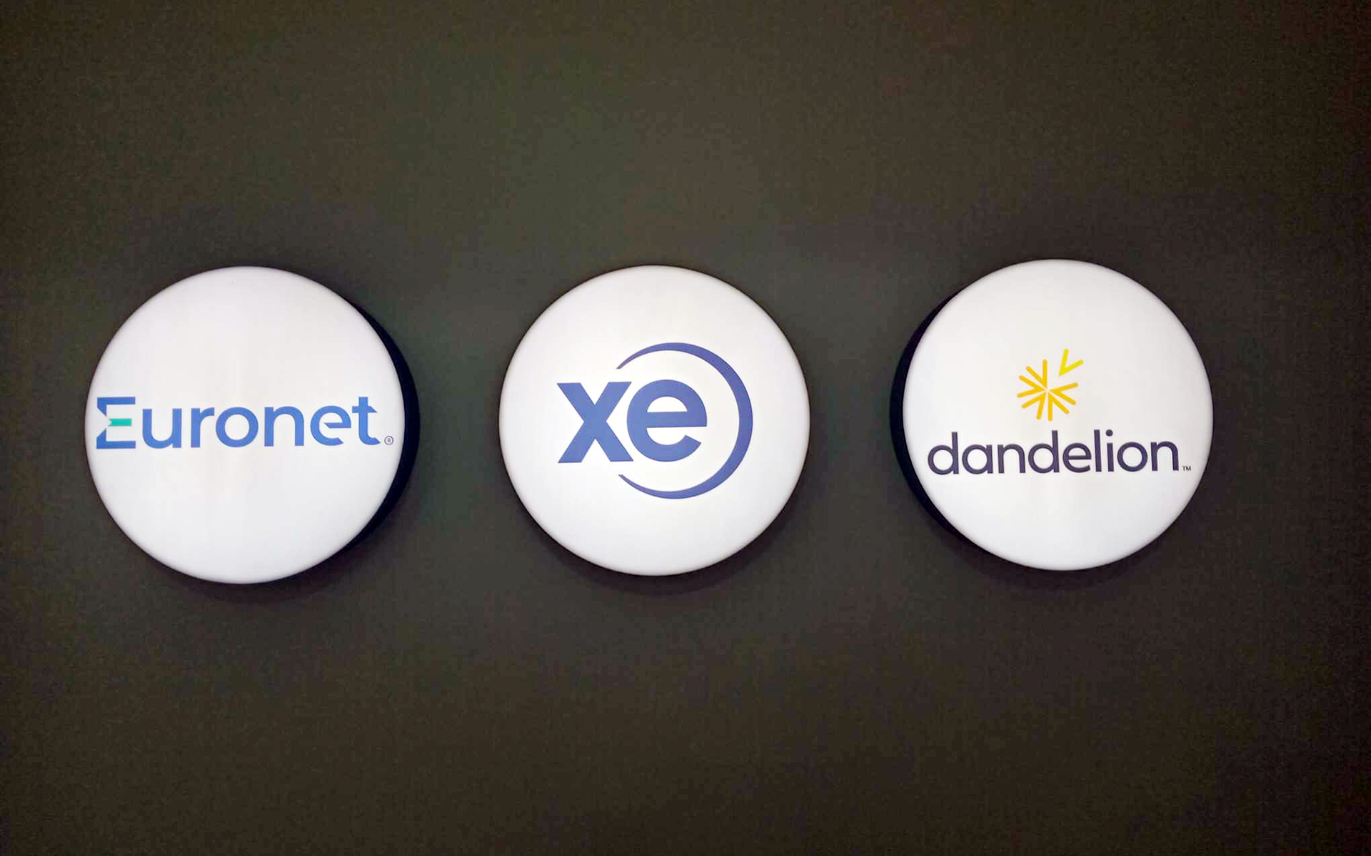Euronet, XE, and Dandelion logos